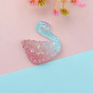Close-up detail of the iridescent gradient glitter swan resin flatback DIY craft accessory.