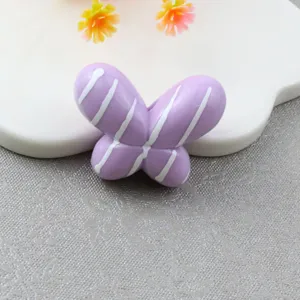 Detailed shot of purple striped chubby butterfly loose bead for DIY phone charms.