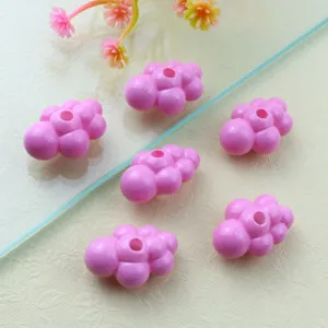 Close-up of pink acrylic cloud beads, smooth surface, perfect for DIY jewelry making details.