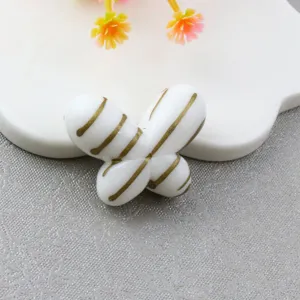 Detail view of large striped fat butterfly loose bead, DIY jewelry and phone chain accessory