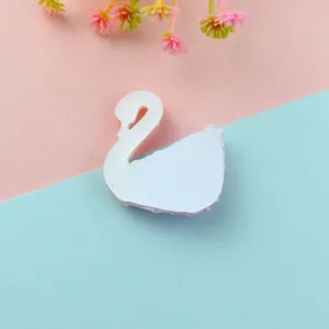 Close-up detail of white resin swan flatback patch, ideal for DIY craft phone cases.