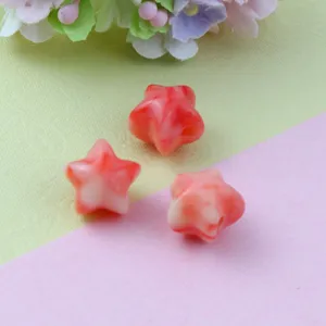 Close-up detail of two-color gradient acrylic fat star beads, ideal for DIY jewelry parts.