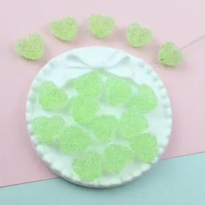 Green acrylic sugar heart beads DIY jewelry charms detail view, sparkling candy design pieces.
