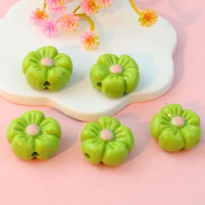 Green acrylic flower beads with pink centers for DIY phone charms, jewelry making and crafts details.