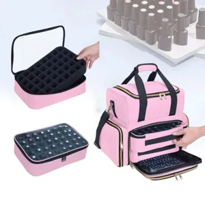 Detail view of the pink multi-layer nail organizer bag showing removable foam slot and storage layers.