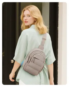 Casual versatile travel crossbody bag for women, mini vertical puffer chest bag in grey.