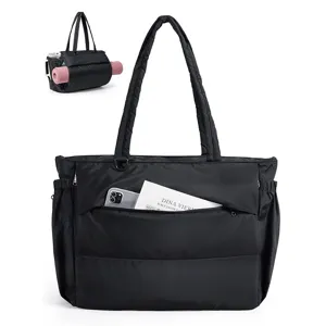 Detail view of black quilted puffer tote bag, large capacity shoulder bag with front pocket.
