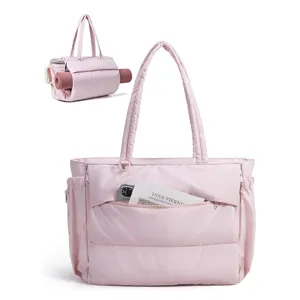 Pink quilted tote bag detail showing front pocket and yoga mat holder design for daily gym use.