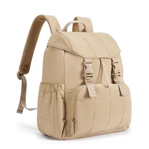 Detail view of a stylish quilted beige backpack with buckle straps and front pocket.