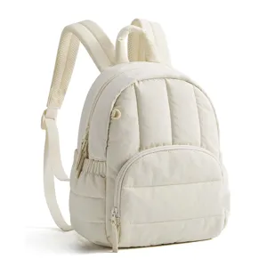 Detail view of the lightweight mini quilted backpack showing soft fabric and smooth zipper.