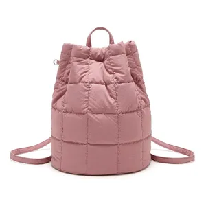 Pink quilted puffy drawstring backpack detail shot, showing soft padded casual daypack design.
