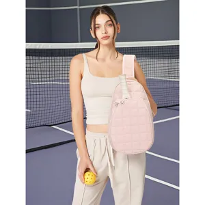 Pink quilted tennis racket sling bag, stylish crossbody sports backpack for active women.