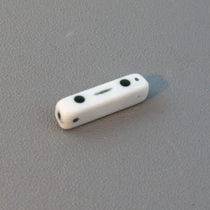 Detail view of white square double-hole acrylic spacer bead for DIY jewelry making accessories.