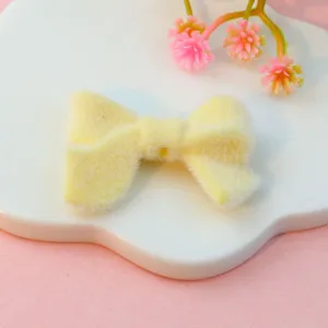 Yellow flocked bow shaped bead detail for DIY jewelry making and cute craft accessories.