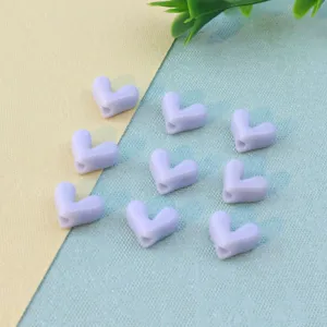 Detail shot of light purple heart beads, smooth resin surface, perfect for DIY jewelry crafting.