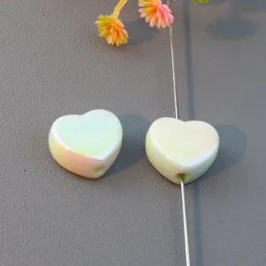 Detail shot of macaron color glossy heart-shaped loose beads, ideal for jewelry making accessories.