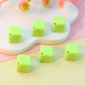 Light green acrylic cube beads with diagonal holes, perfect for DIY jewelry making and phone charms.