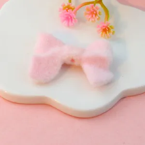 Fluffy pink plush bow charm bead for cute DIY jewelry making and craft accessory.