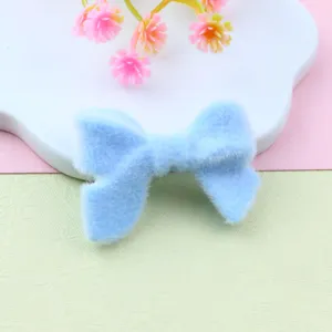 Flocked blue bow charm detail close-up, perfect for DIY jewelry beading and crafting projects.