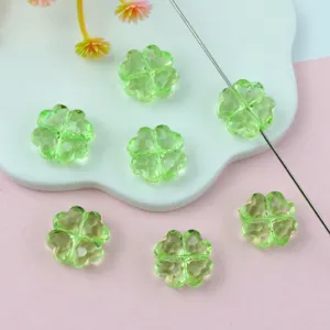 Transparent green four-leaf clover acrylic beads, detail shot of DIY jewelry making accessories.