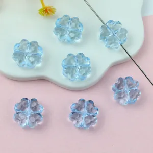 Translucent blue acrylic clover shape loose beads close-up for DIY jewelry making accessories.