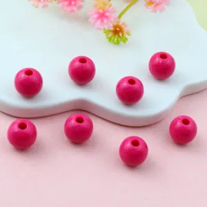 Acrylic pink round beads detail shot, smooth surface with center hole for DIY jewelry making.