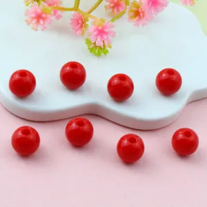 Red acrylic round beads detail shot, perfect for DIY jewelry making and spacing accessories.