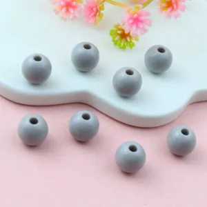 Close-up detail of grey solid acrylic round spacer beads, perfect for DIY jewelry making.