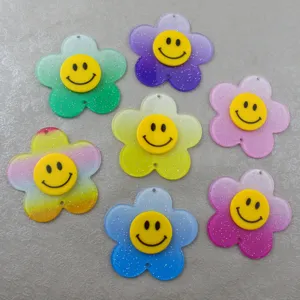 Ciondolo girasole in acrilico glitterato sfumato con viso sorridente per gioielli fai da te.