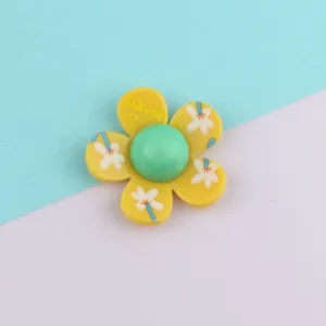 Acrylic flower patch detail shot, vibrant yellow petals and green center for DIY craft use.