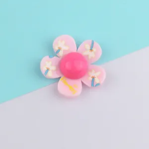Detailed view of the pink acrylic flower charm designed for DIY hair clips and bag accessories.