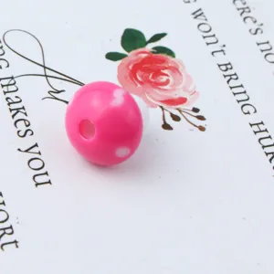 Close-up detail of 12mm pink acrylic mushroom spacer bead with center hole for DIY jewelry making.
