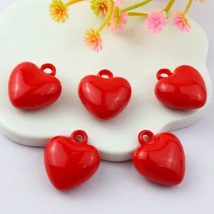 Glossy red acrylic heart charms with loops, perfect for DIY jewelry and cute crafting details.