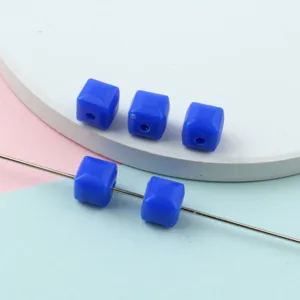 Close-up detail of blue faceted acrylic square spacer beads for DIY jewelry making accessories.