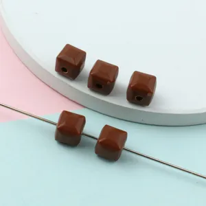 Faceted acrylic square beads detail shot, solid color cube spacer beads for jewelry making.