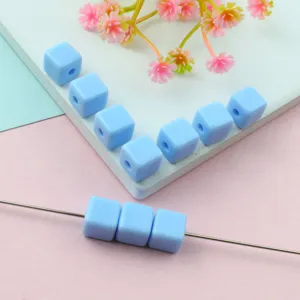 Close-up detail of light blue acrylic cube beads, perfect for DIY jewelry making.