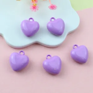 Detailed view of 17mm purple acrylic heart charms with loop for DIY jewelry making.
