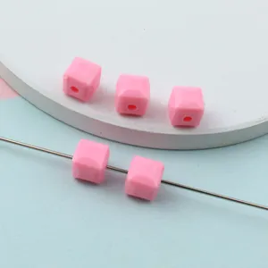 Pink faceted acrylic square beads for DIY jewelry making and spacer design details.
