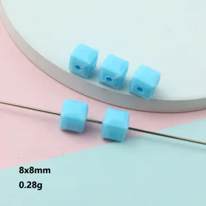 Detailed view of 8x8mm faceted acrylic square beads, perfect for jewelry spacer design.