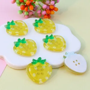 Close-up of cute acrylic strawberry 4-hole buttons, colorful DIY jewelry and craft accessories.