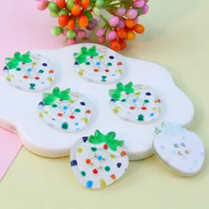 Detailed view of colorful acrylic strawberry shaped 4-hole buttons for DIY crafts and accessories.