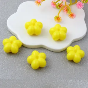 Close-up of 18mm acrylic yellow plum blossom beads, perfect for DIY jewelry and phone chains.