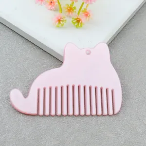 Cute pink cat shaped acrylic comb detail shot, smooth edges with convenient hanging hole.