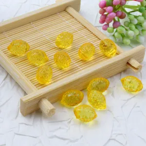 Close-up detail of yellow lemon acrylic beads, ideal for DIY jewelry and phone charms.