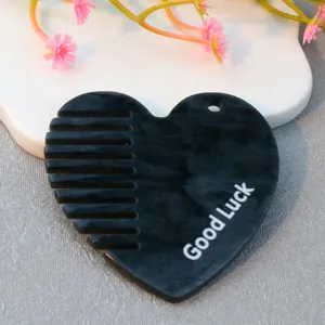 Acrylic heart-shaped mini comb with a hanging hole and cute Good Luck printed detail.