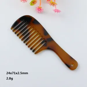 Detailed view of the mini tortoiseshell comb with hanging hole, compact portable hair tool.