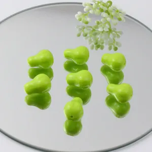 Detailed view of light green pear-shaped acrylic loose beads for DIY bracelets and charms.