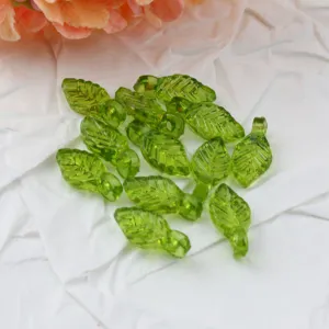 Green acrylic leaf beads detail showing transparent crystal texture for DIY jewelry making.