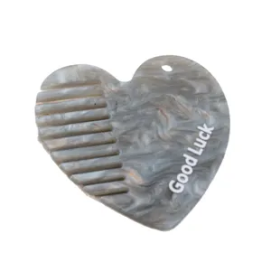 Acrylic heart-shaped hair comb accessory with hanging hole and grey marble texture design main view
