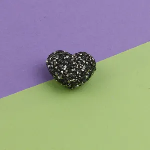 Close-up detail of black glitter heart acrylic sugar bead for DIY jewelry making accessories.